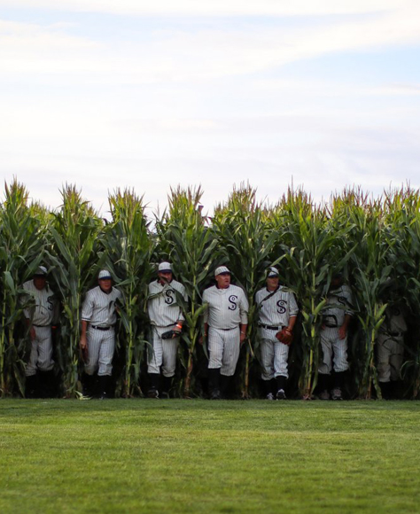 White sox players walking out of a corn field