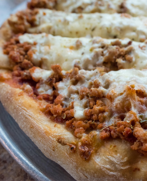 A close up of a sausage pizza