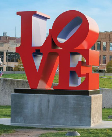 Red sculpture that says love