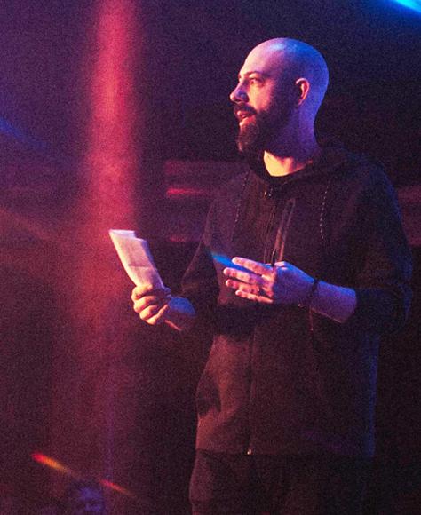 Ben Milne speaking on a stage.