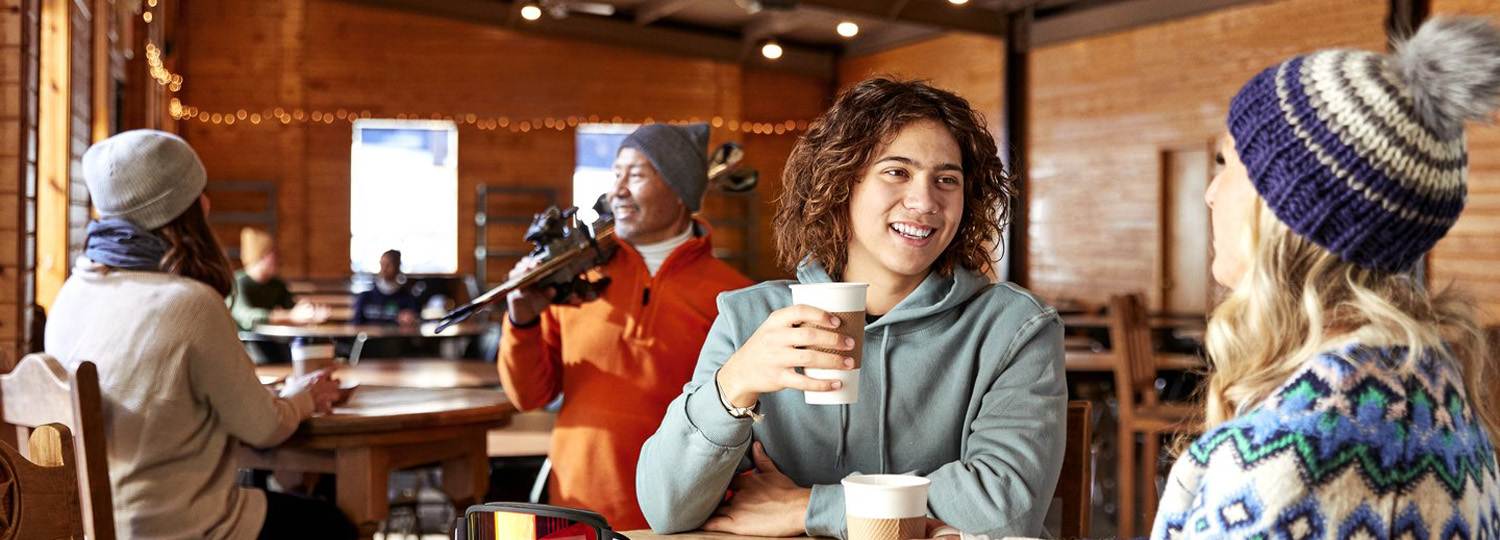 Young adult male enjoying a cup of coffee.