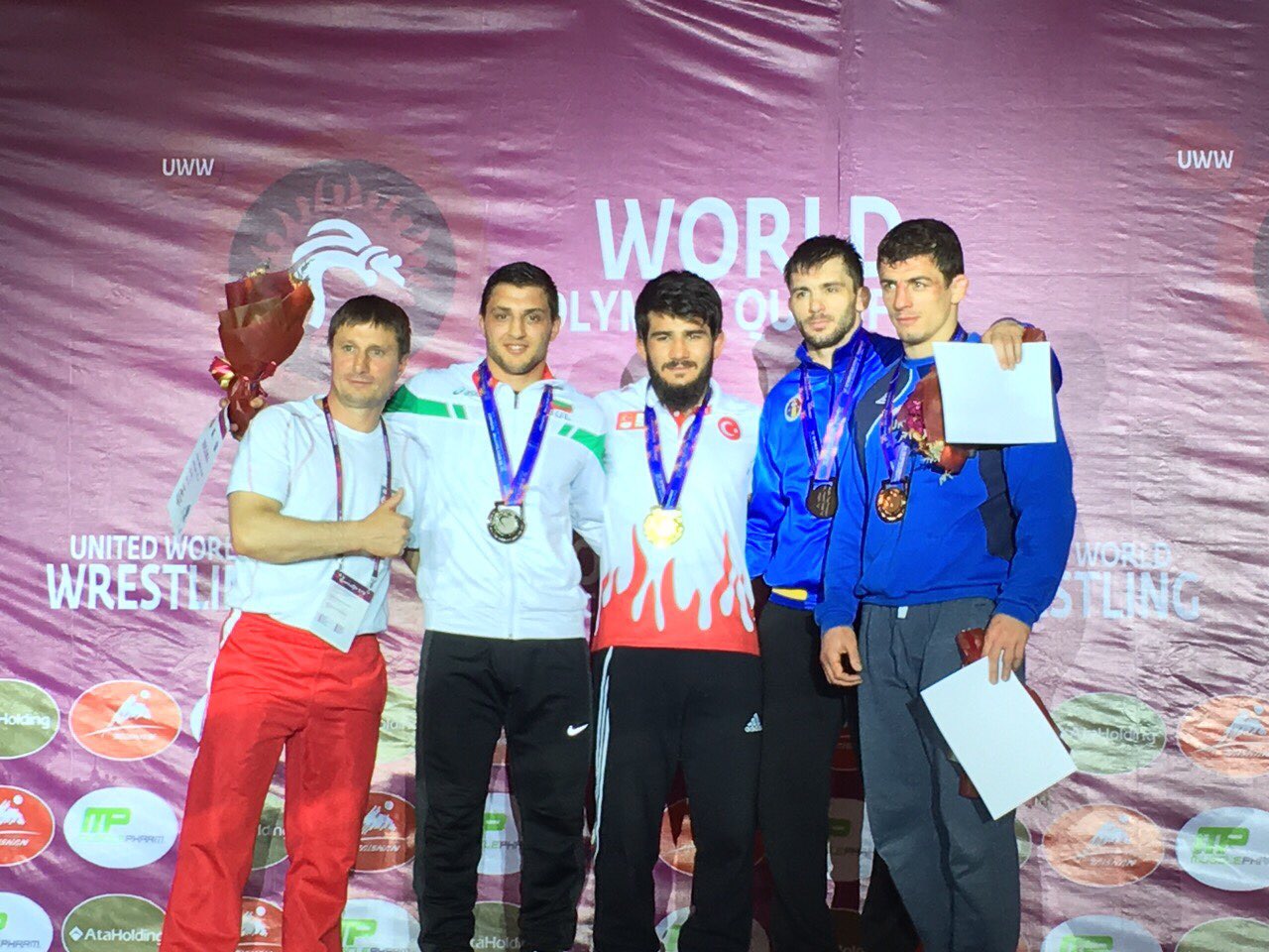 Group of wrestlers standing with medals