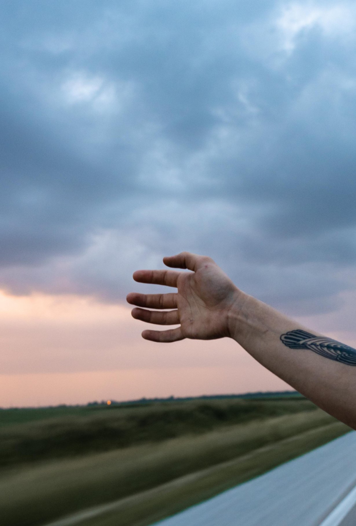 An arm reaching out a car window photographed by Isaac Jarnigan