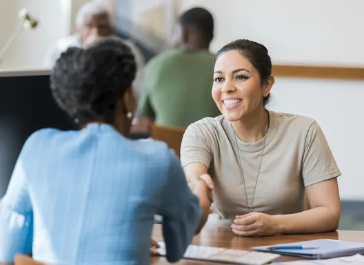 A veteran shakes hands with an employer