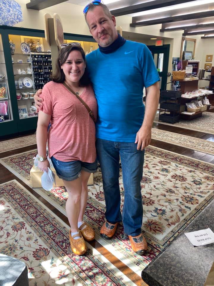 a couple posing in wooden clog shoes
