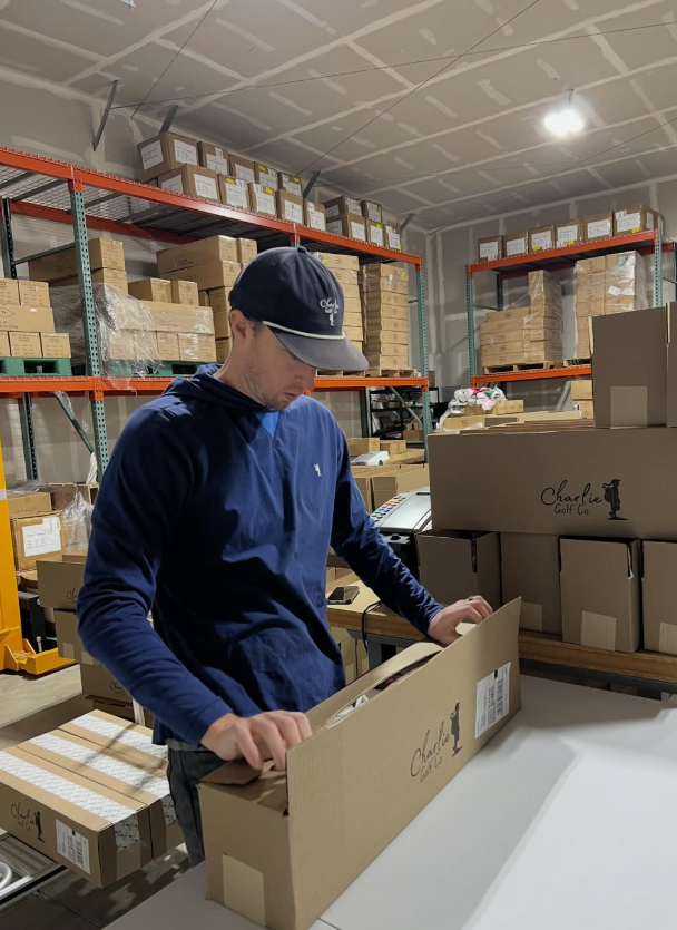 Tyler Johnson packing a charlie golf co box