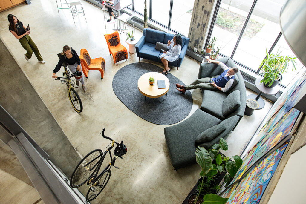 Overhead shot of four people in a coworking lobby space